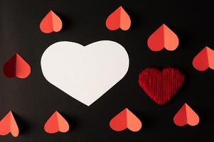 White hearts and red hearts made of paper are placed photo