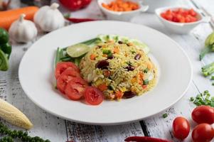 Fried rice in a plate on a white wooden floor