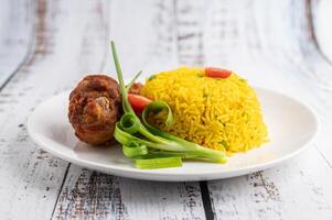 Chicken Biryani in a plate on a white wooden floor photo