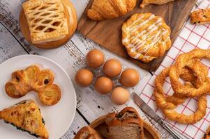 Various breads and eggs on red white cloth. Selective focus. photo