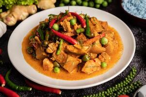 Red curry with pork in a white plate photo