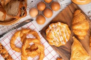 Various breads and eggs on red white cloth. Selective focus. photo