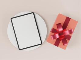 The tablet is placed on a white pedestal and has a gift box. photo