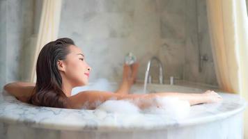 Young asian woman taking a bath video