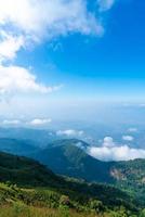 Beautiful mountain layer with clouds and blue sky photo