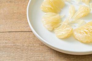 Fresh peeled pomelo, grapefruit or shaddock photo