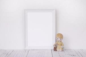 White frame with ceramic figurine photo