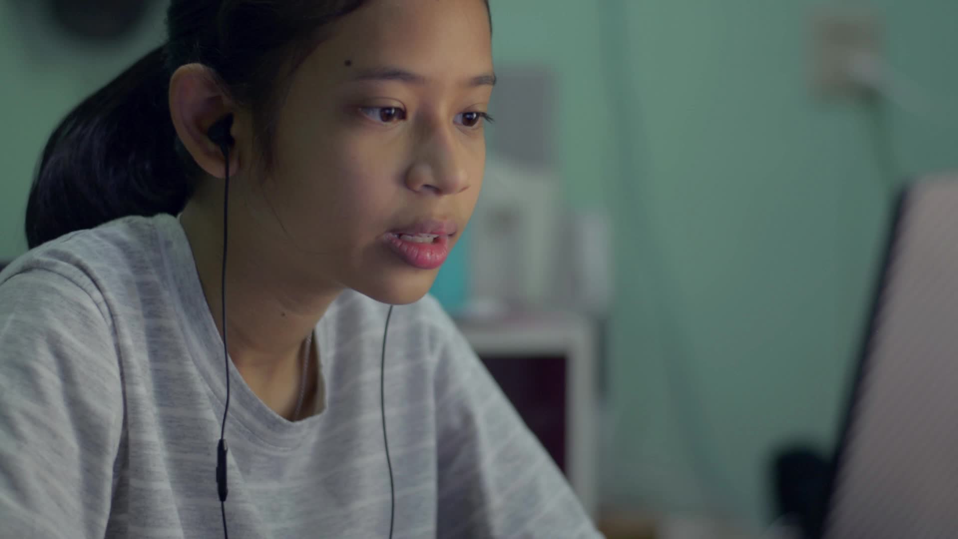 Teen girl talking on a video call on laptop at home