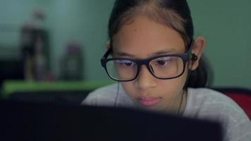 Girl in eyeglasses watching distance lesson online on laptop at home. video