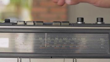 Man's finger presses a button to play old cassette tape player. video