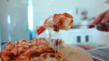 slow motion hand av asiatisk kvinna med kniv för att sätta ostliknande pizza upp video
