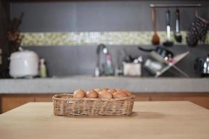 huevos frescos de granja apilados en cestas de madera en la cocina de la casa. foto