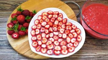 Strawberry slices on a white plate in the shape of a heart photo