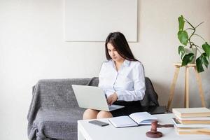 lawyer working at the laptop sitting on the couch photo