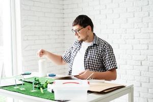 Young man making renewable energy project dummy photo