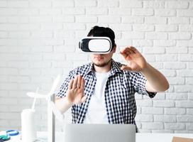Engineer or designer using VR glasses visualising energy project