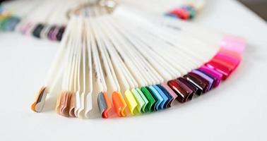 Colorful plastic nail tips on the table in manicure salon photo