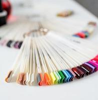 Colorful plastic nail tips on the table in manicure salon photo