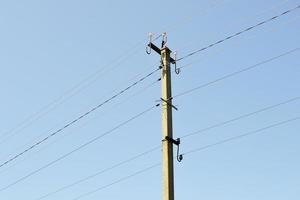 Power electric pole with line wire on colored background close up photo