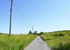 Beautiful empty asphalt road in countryside on colored background photo