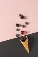 Blueberries, cherries and blackberries in a waffle cone photo