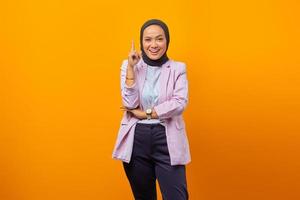Attractive businesswoman raising index finger and saying her idea photo