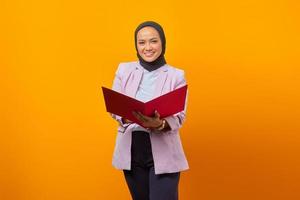 Beautiful asian woman holding folders while looking at camera photo