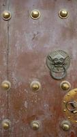 Ancient door lion ring in Tulou Temple of Beishan Mountain China photo
