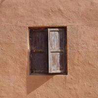 old house wall and wooden window Tuyoq village valleyXinjiang China. photo