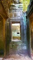 Stone ruin window at Ta Prohm Temple , Siem Reap Cambodia. photo