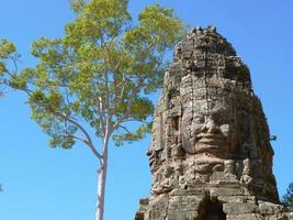 Stone carving of face at Banteay Kdei, in Siem Reap Cambodia photo