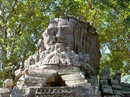 Stone carving of face at Banteay Kdei, in Siem Reap Cambodia photo