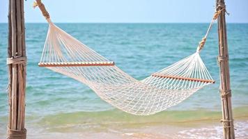 Empty Hammock on the tropical beach sea ocean for leisure travel video