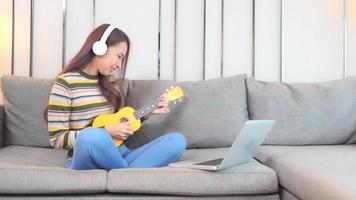 Young asian woman play ukulele video