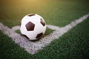 soccer ball on the white line at stadium photo