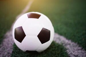 soccer ball on the white line at stadium photo