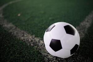 soccer ball on the white line at stadium photo