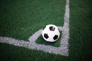 soccer ball on the white line at stadium photo
