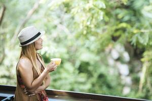 Happy young woman with latte coffee in morning photo