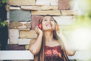 Happy young woman relax with listen favorite music at cafe photo