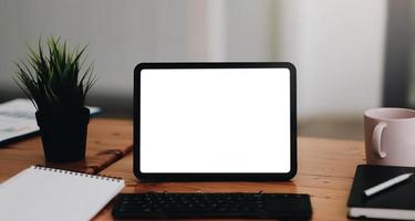 Laptop blank screen on wood table with coffee cafe background photo