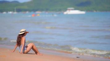 Asian woman enjoys a day at the beach video