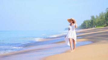 Asian woman enjoys a day at the beach video