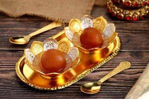 Indian Dessert Sweet Food Gulab Jamun in a traditional metal bow photo