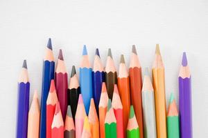 seamless colored pencils row on white painting paper background photo
