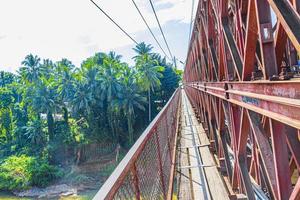 Old French Bridge of wooden board Luang Prabang Laos Asia. photo