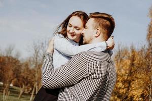 Romantic couple in autumn park - love, relationship and dating concept photo