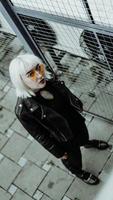Portrait of woman with white hair and glasses. Modern urban style photo