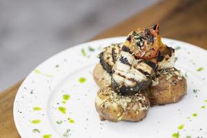 rustic grilled fish with roast potato and tomato photo