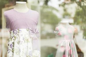 young girl dresses in shop display photo